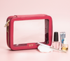 Pink cosmetics bag made from leather with clear vinyl windows